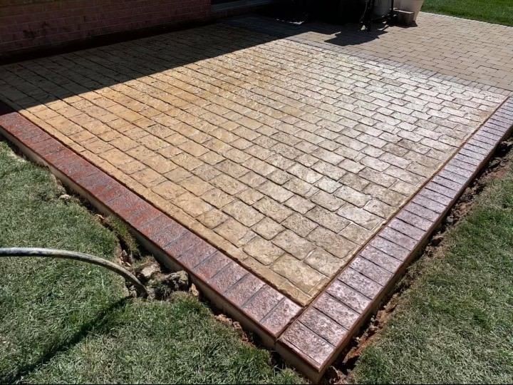 A brick patio with a hose attached to it