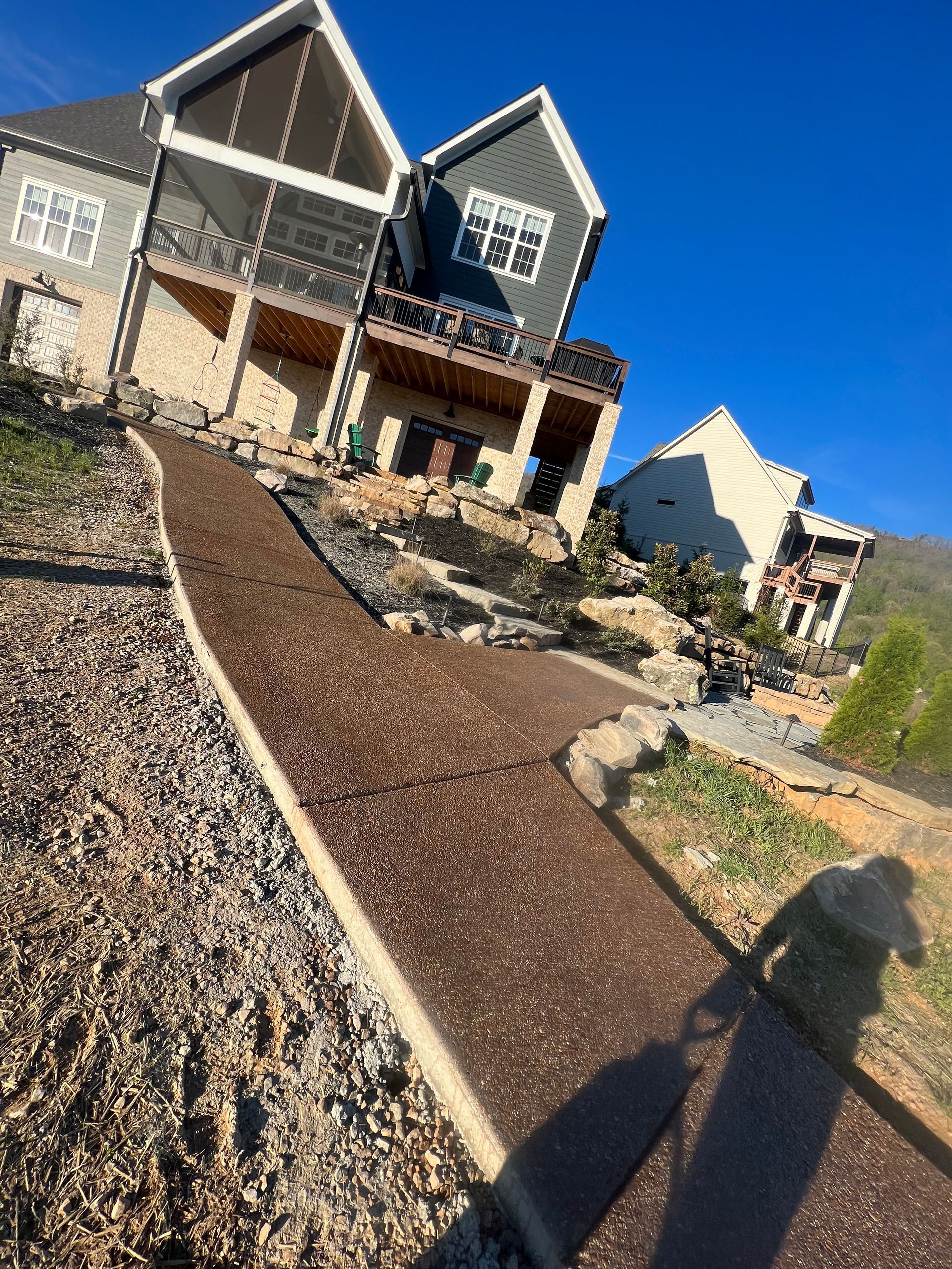 A house is sitting on top of a hill with a path leading to it.