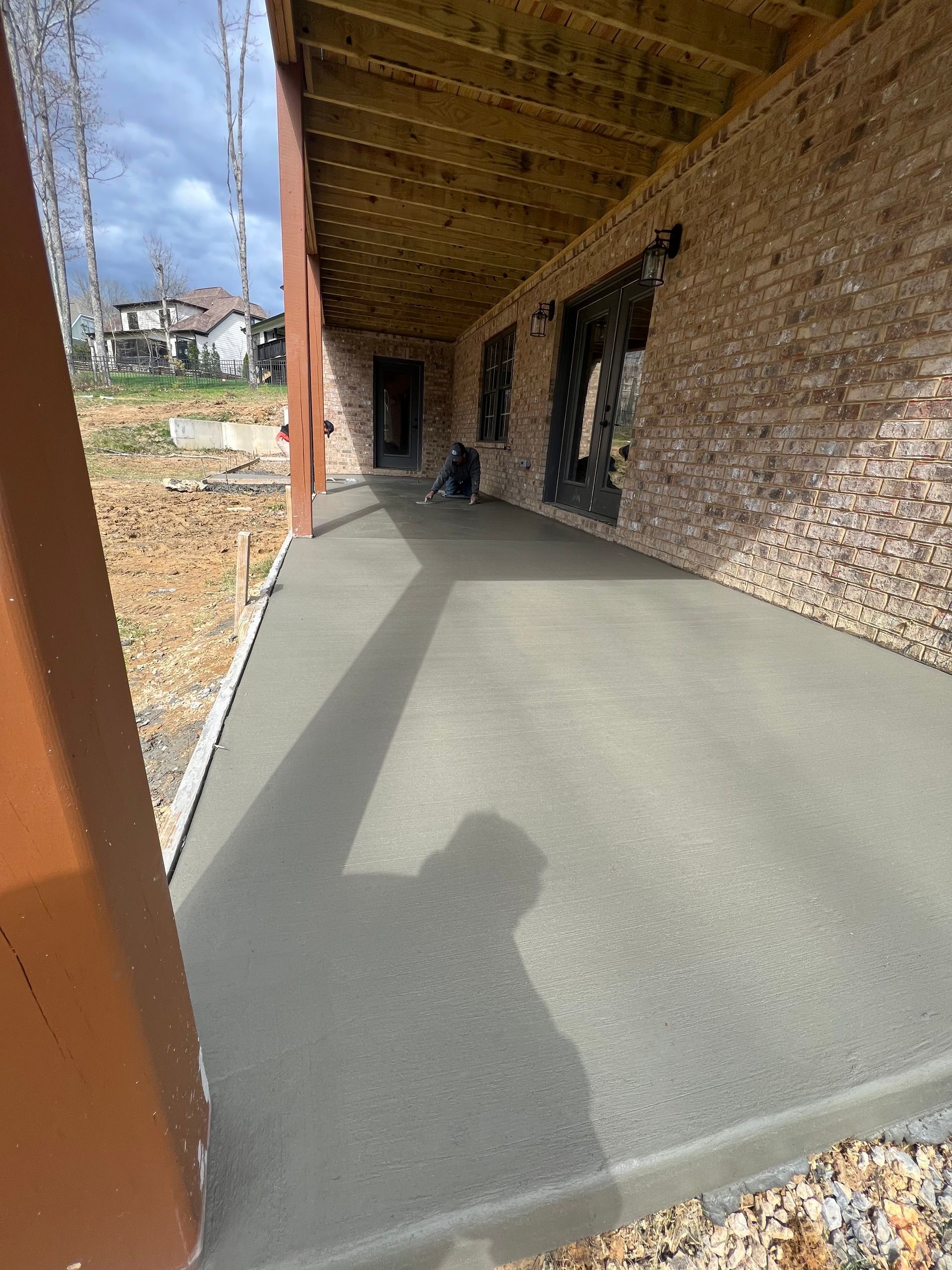 A brick building with a concrete walkway leading to it.