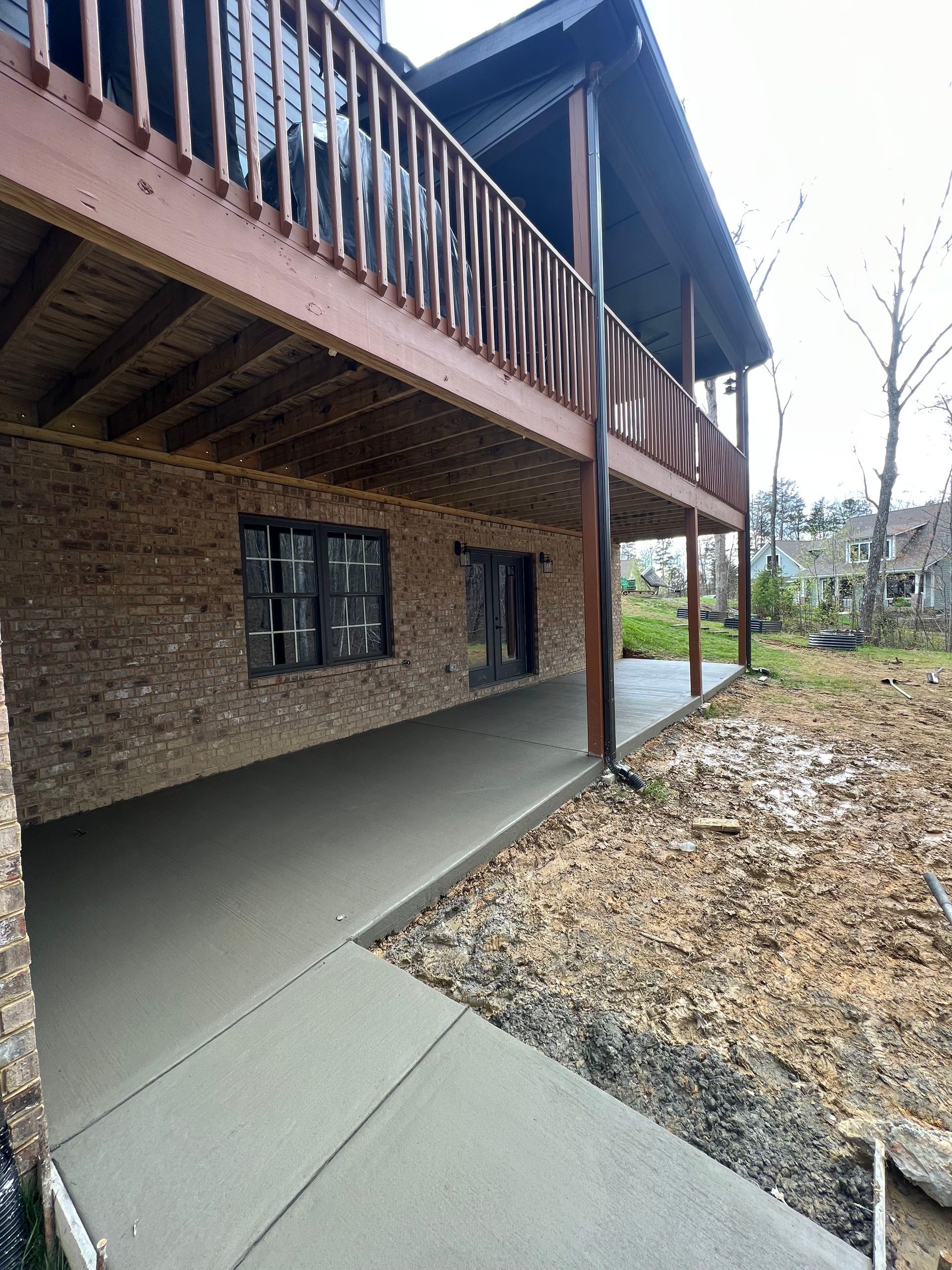 A brick house with a wooden deck underneath it