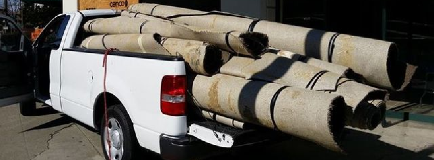 pickup truck with rolled up rugs in back
