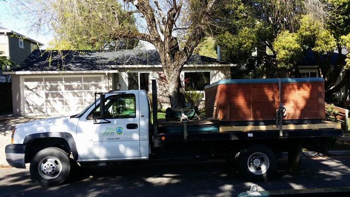 Bay Junk truck in front of house