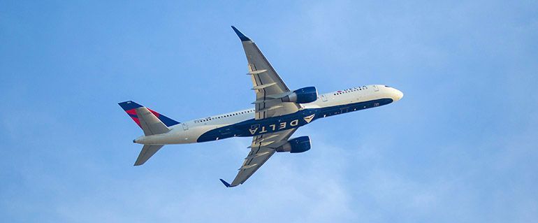 Delta Airlines plane in blue sky