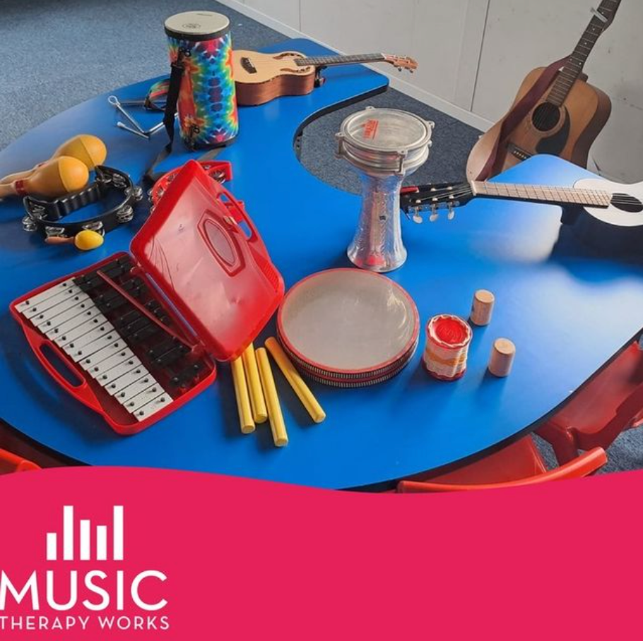 A blue table with musical instruments on it and the words music therapy works
