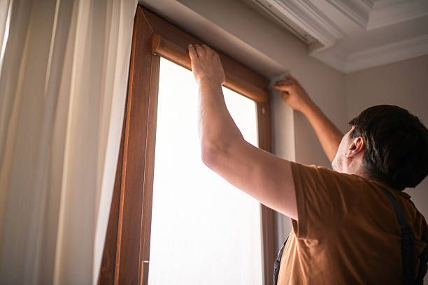 A close-up of white horizontal window blinds.