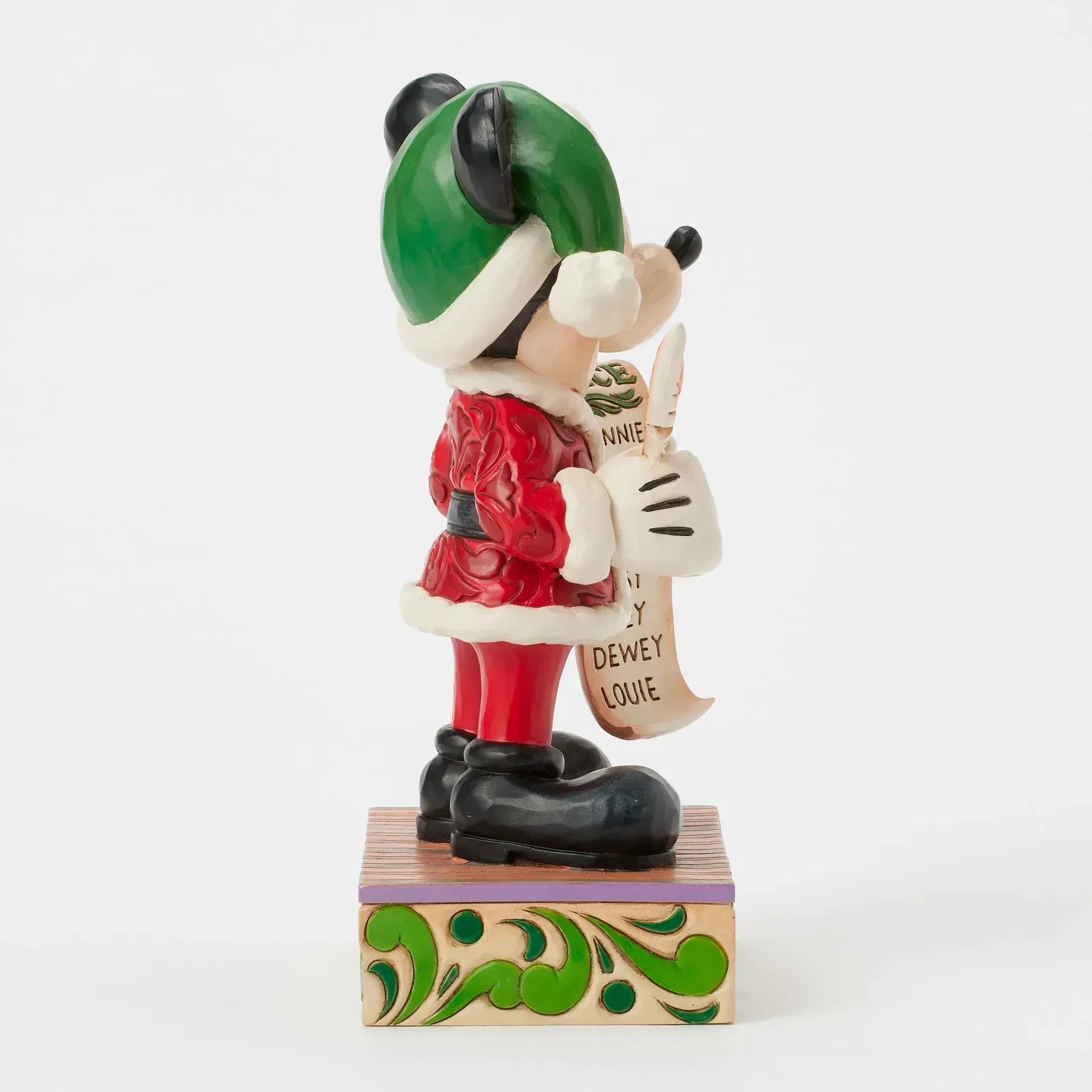 Een beeldje van Mickey Mouse verkleed als de Kerstman, die een lijst vasthoudt.