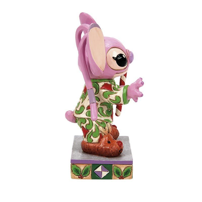 Een beeldje van een engel van lilo en stitch die een zuurstok vasthoudt.