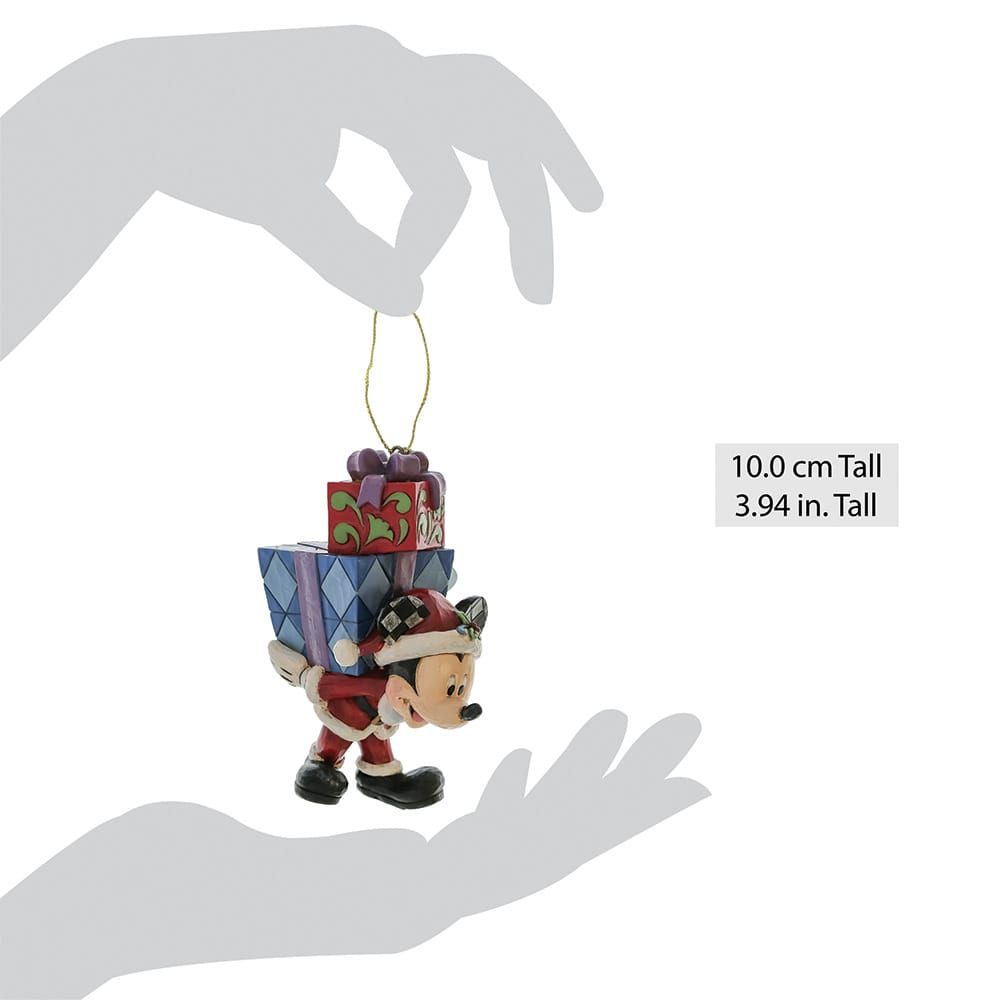 Een hand houdt een Mickey Mouse-ornament vast met cadeautjes op zijn rug.