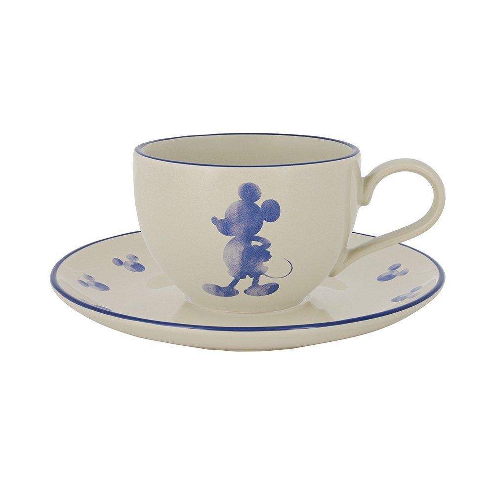 Een witte kop en schotel met een blauwe Mickey Mouse erop