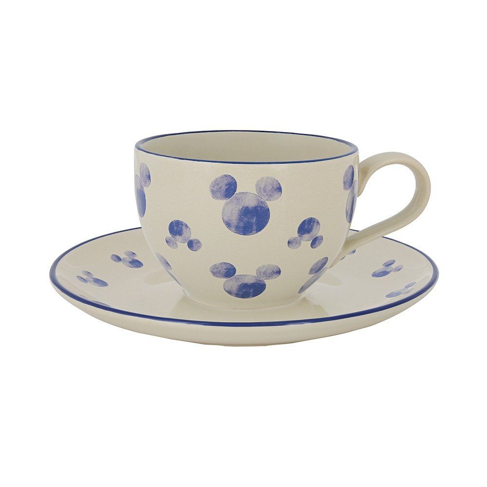 Een witte kop en schotel met blauwe Mickey Mouse erop