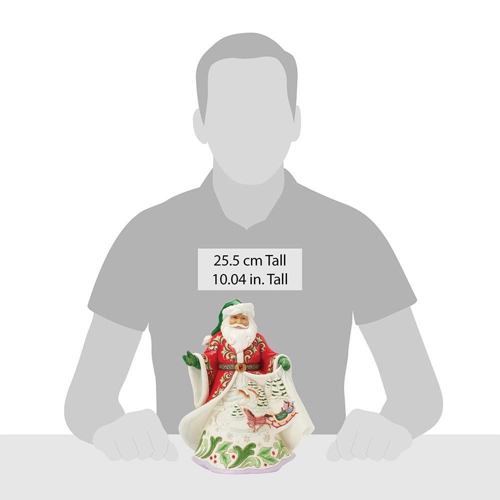 Een beeldje van de Kerstman houdt een deken en een slee vast.