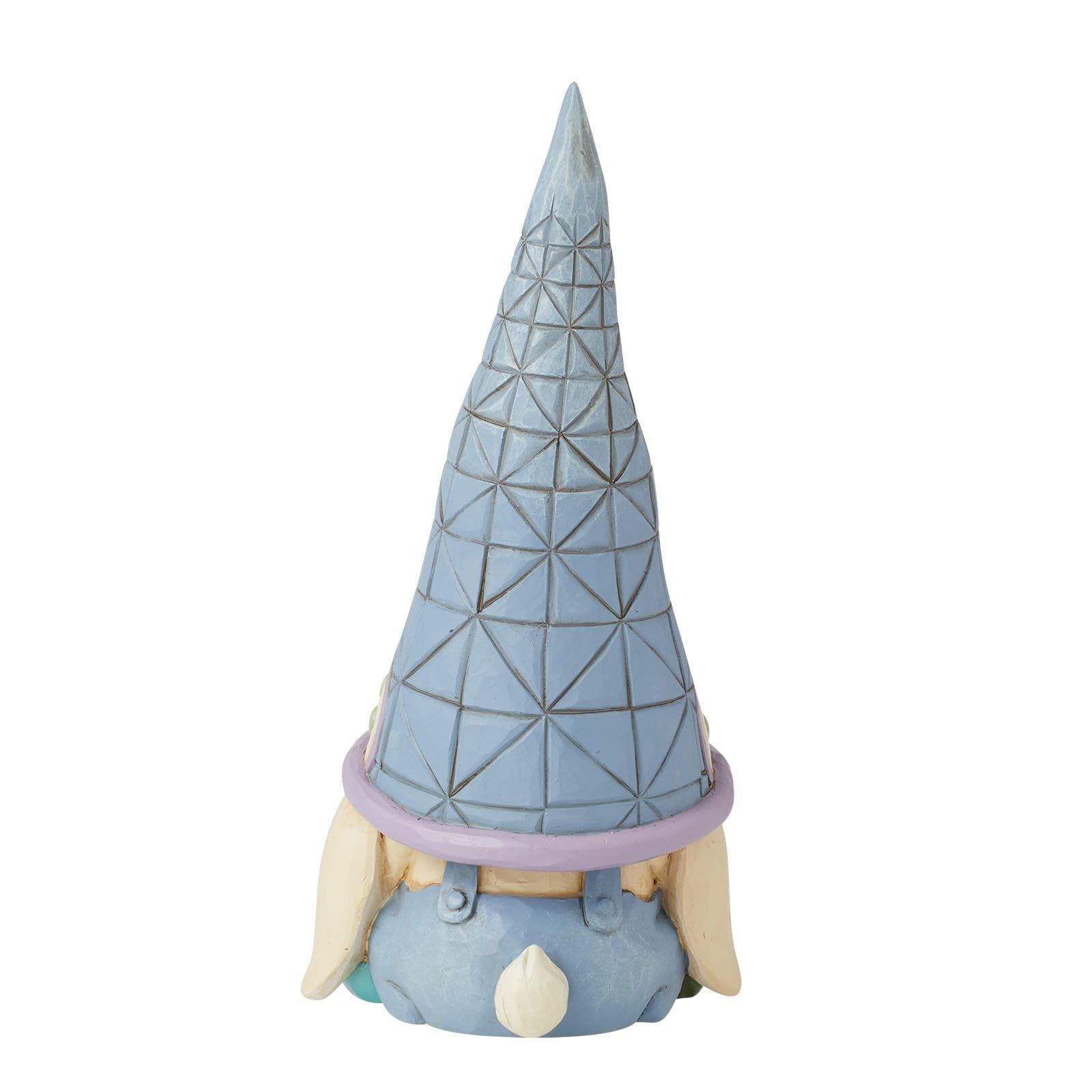 Een beeldje van een kabouter met een blauwe kegelhoed