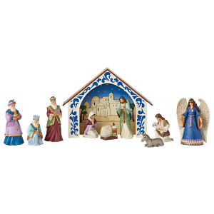 Een kerststal met een kribbe en beeldjes op een witte achtergrond.