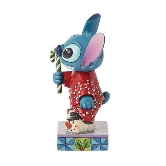 Een beeldje van Stitch van Disney dat een zuurstok vasthoudt.