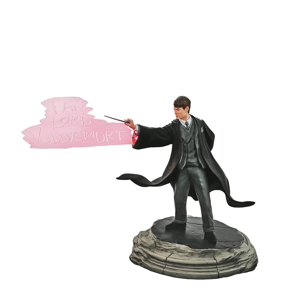 Een standbeeld van harry potter die een toverstaf vasthoudt.