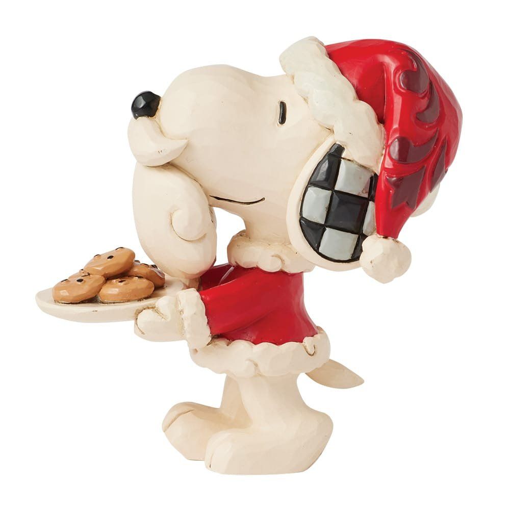 Snoopy draagt ​​een kerstmuts en houdt een bord koekjes vast.