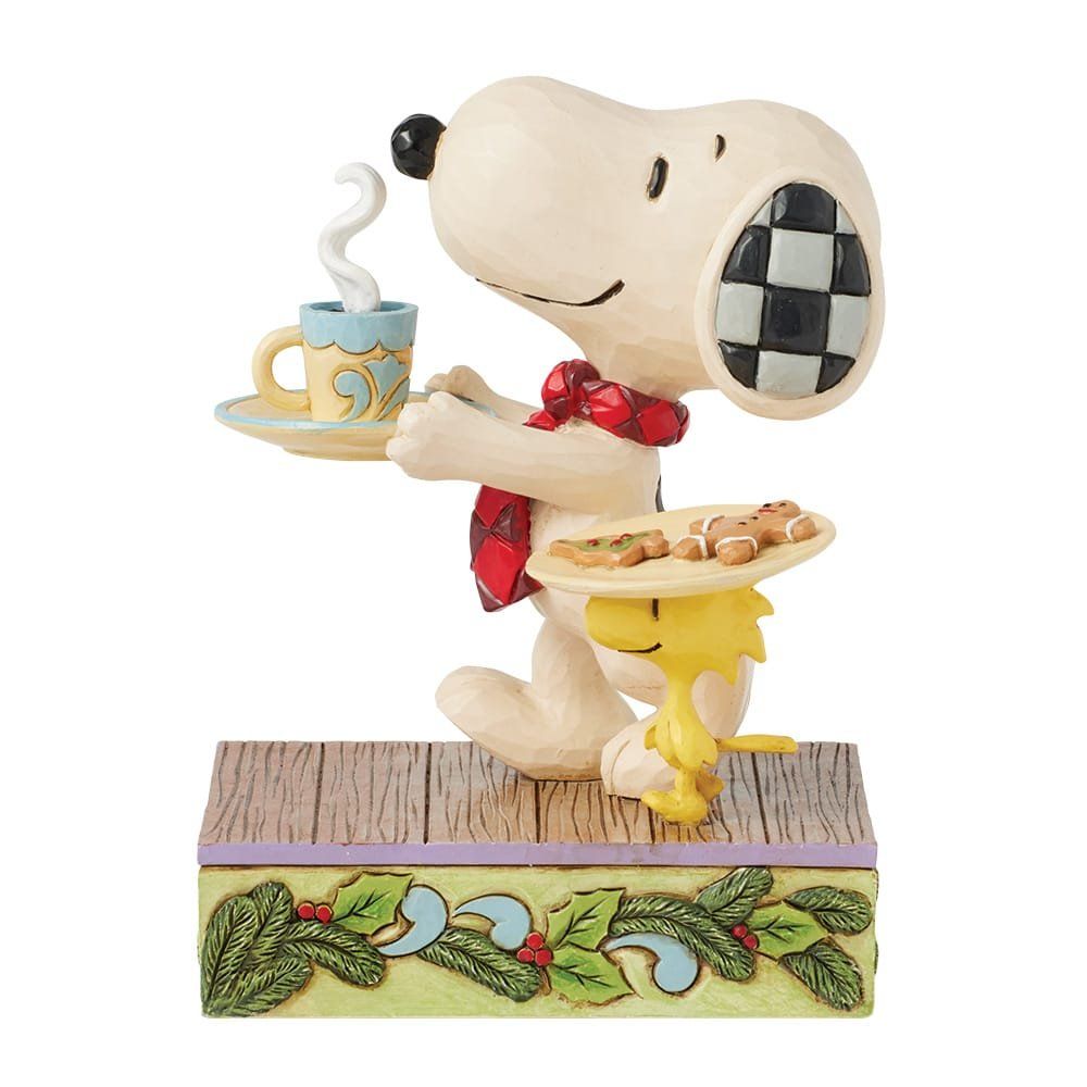 Een beeldje van Snoopy en Woodstock die een kopje koffie en een bordje koekjes vasthouden.