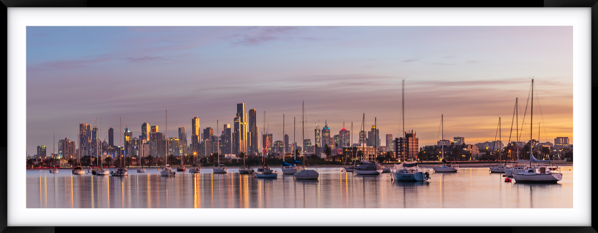 a picture of a city skyline with boats in the foreground
