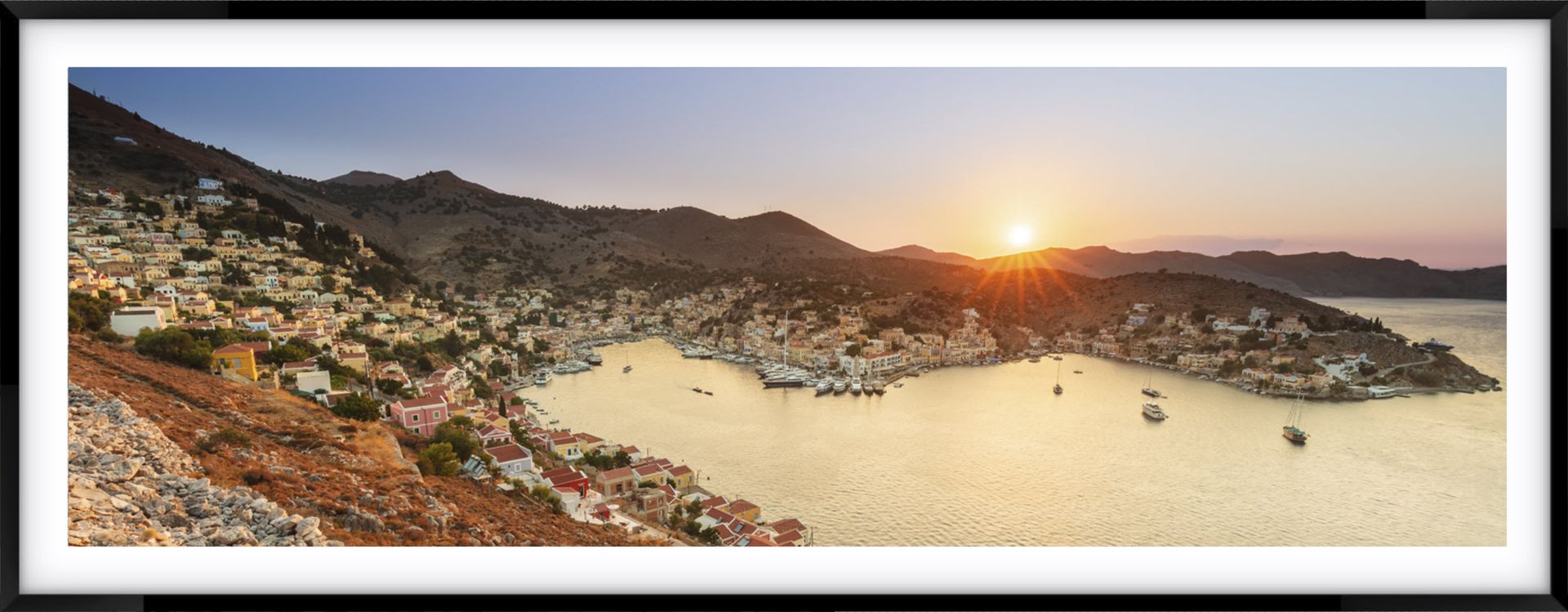 Greek landscape photography at Symi Island - a picture of a boat in the water with mountains in the background