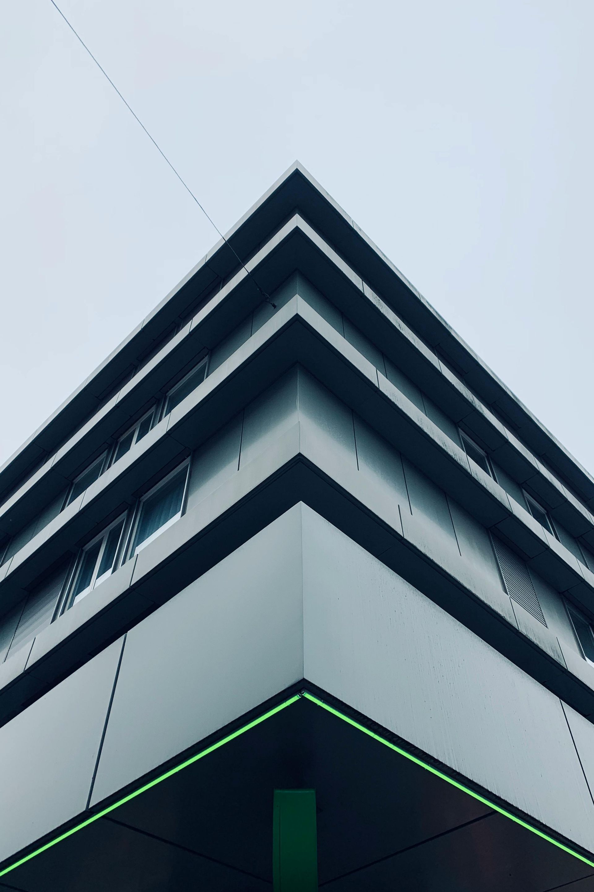 Modern living room with gray sofa, black table, and TV on a cream wall, dark gray accent wall.