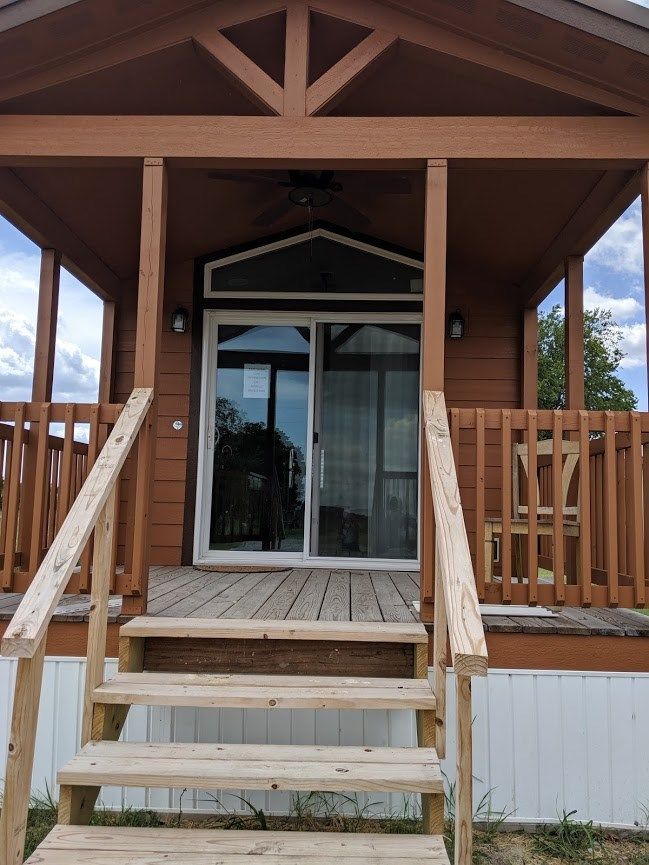 A small house with stairs leading up to the front door
