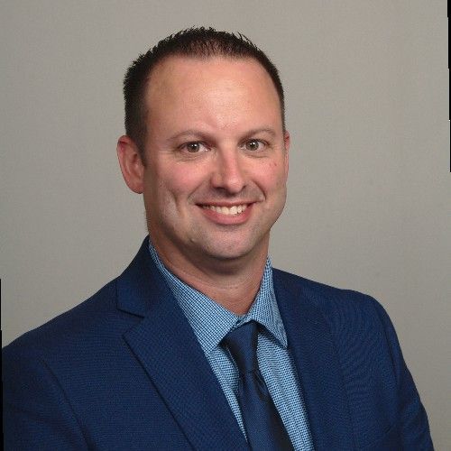 A lake in the middle of a forest with trees in the background