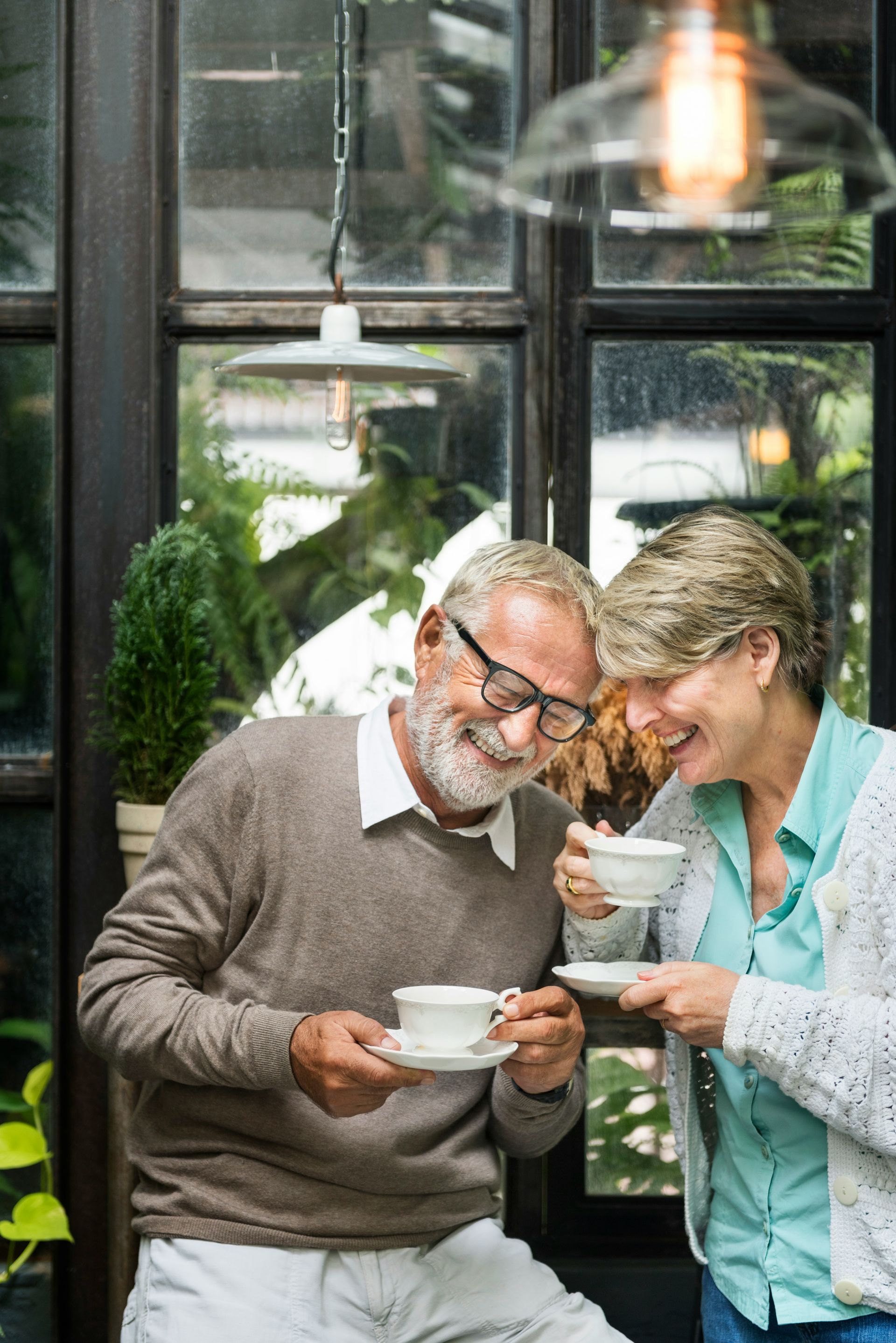 A man with a backpack is standing next to a lake in the woods.