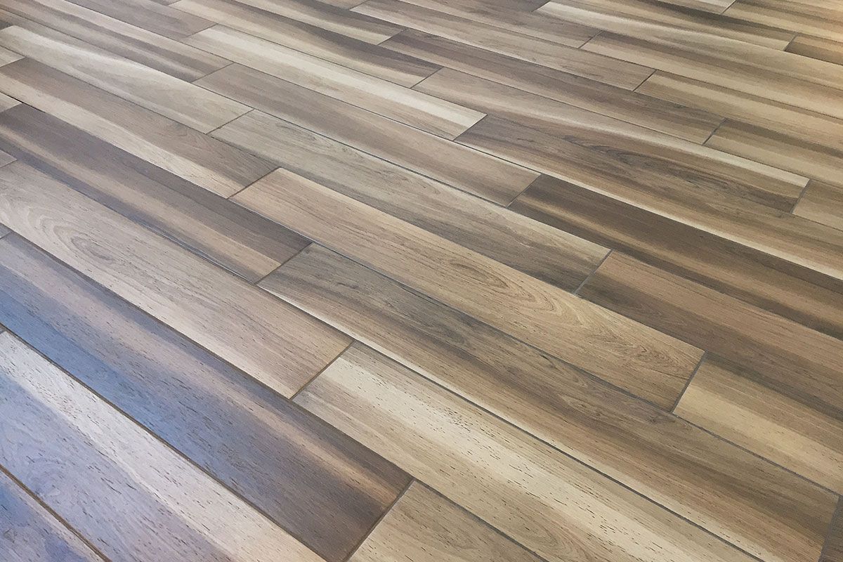 Wooden floor with a mix of light and dark brown planks.