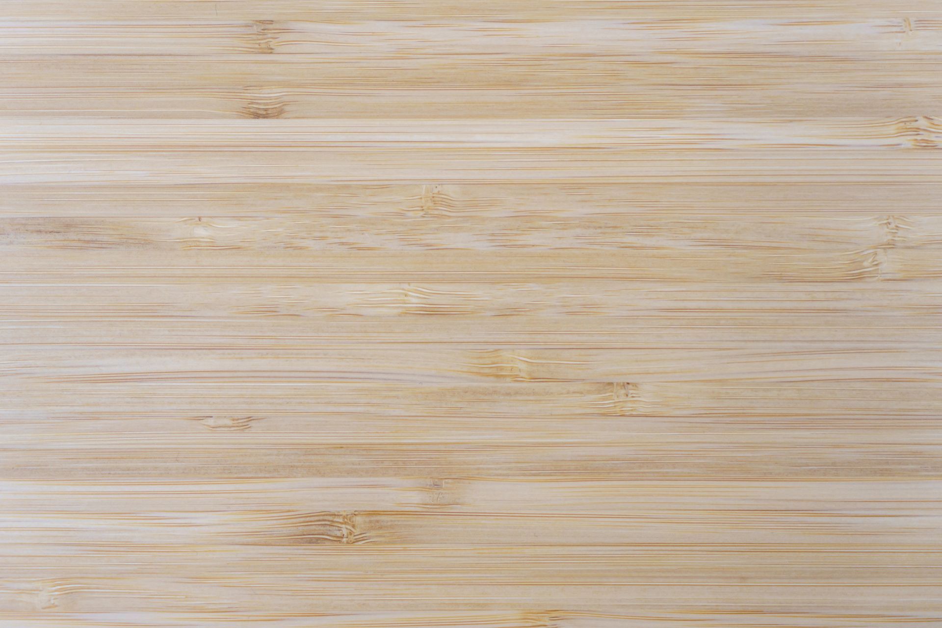 Light-colored bamboo wood grain background. Horizontal lines, varying tones of beige and tan.