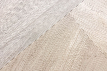 Beige and tan chevron patterned flooring.