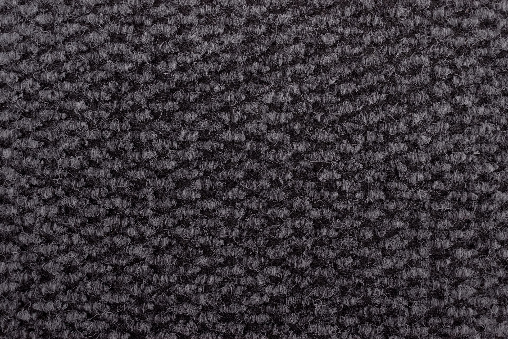 Close-up of dark gray woven fabric, with a textured, bumpy surface. Close-up of dark gray woven fabric, with a textured, bumpy surface.
