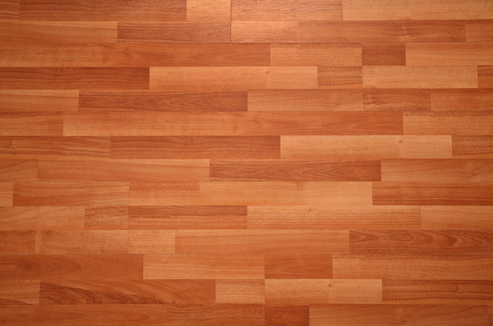 Wooden floor with varying shades of brown planks.