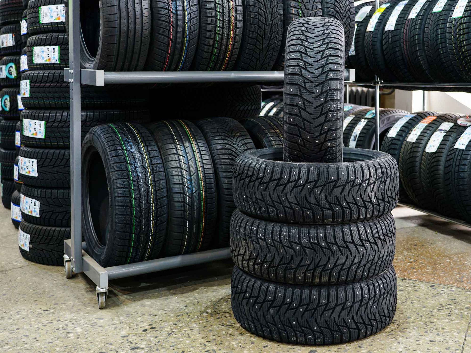 A stack of tires sitting on top of each other in a tire store.