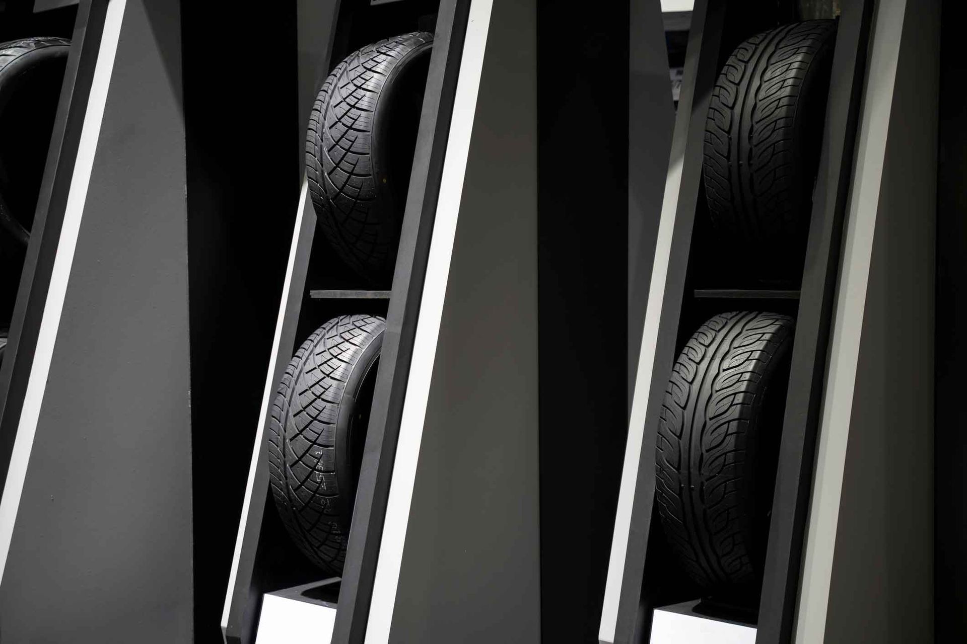 A row of tires stacked on top of each other on a shelf.