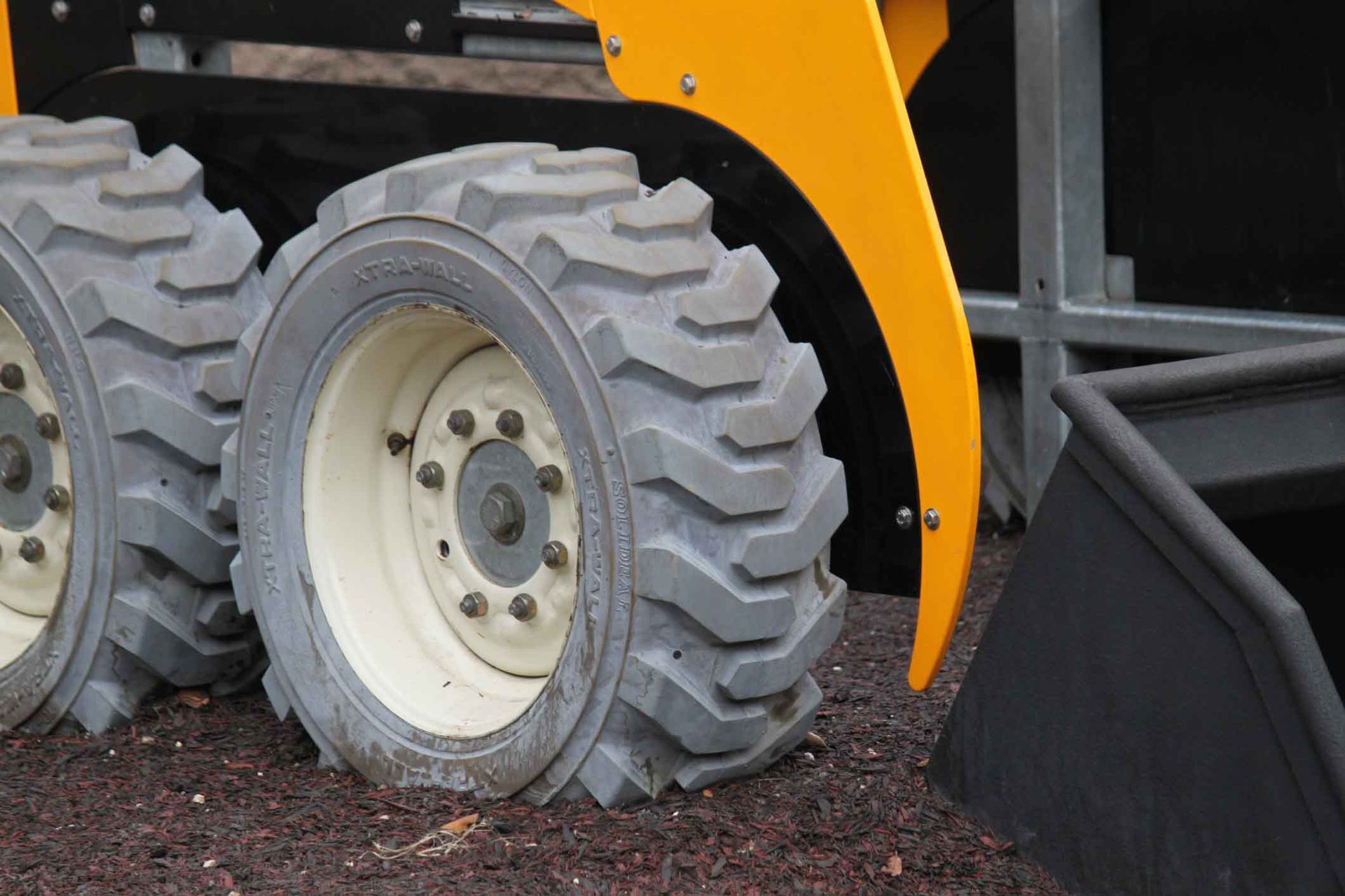 A close up of a tractor with a flat tire