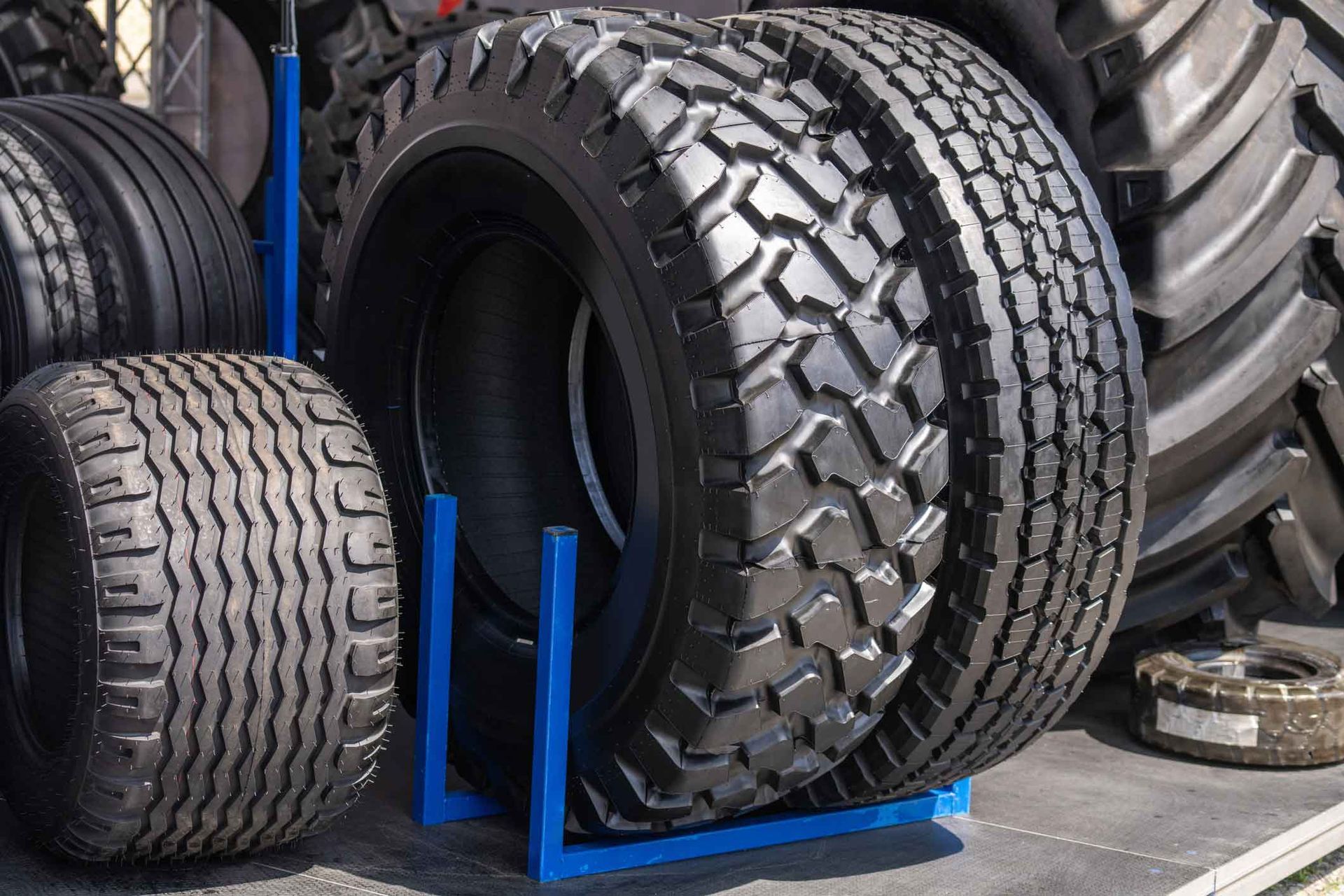 A bunch of tires are stacked on top of each other on a stand.