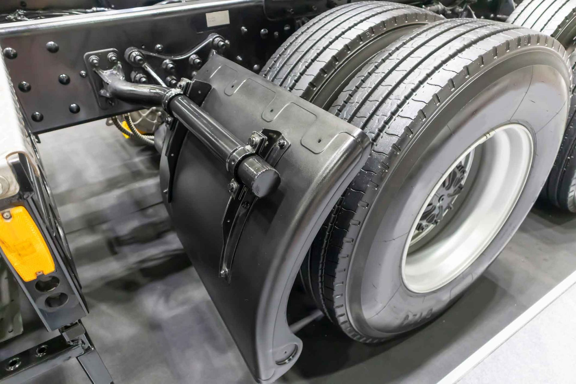 A close up of the rear fender of a semi truck.