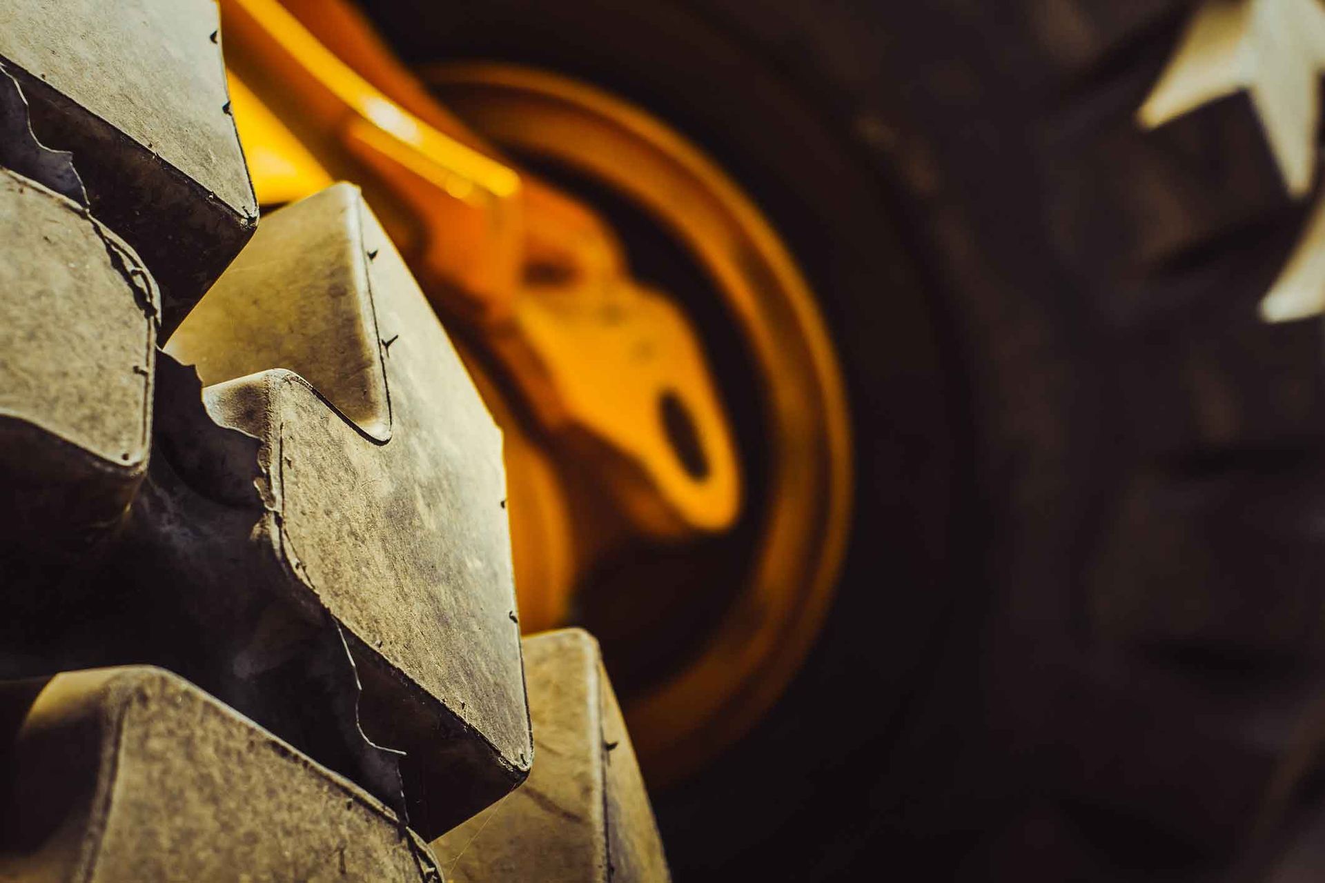 A row of large tires are stacked on top of each other