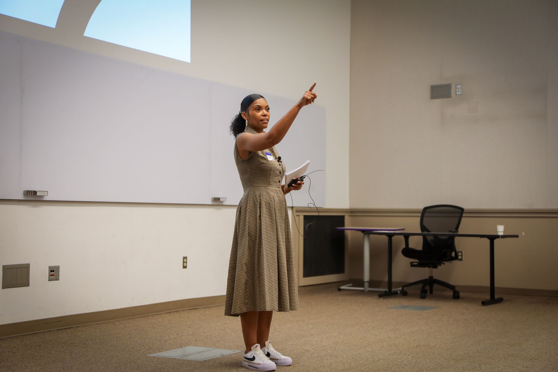 Business team meeting around a table, reviewing documents and discussing.