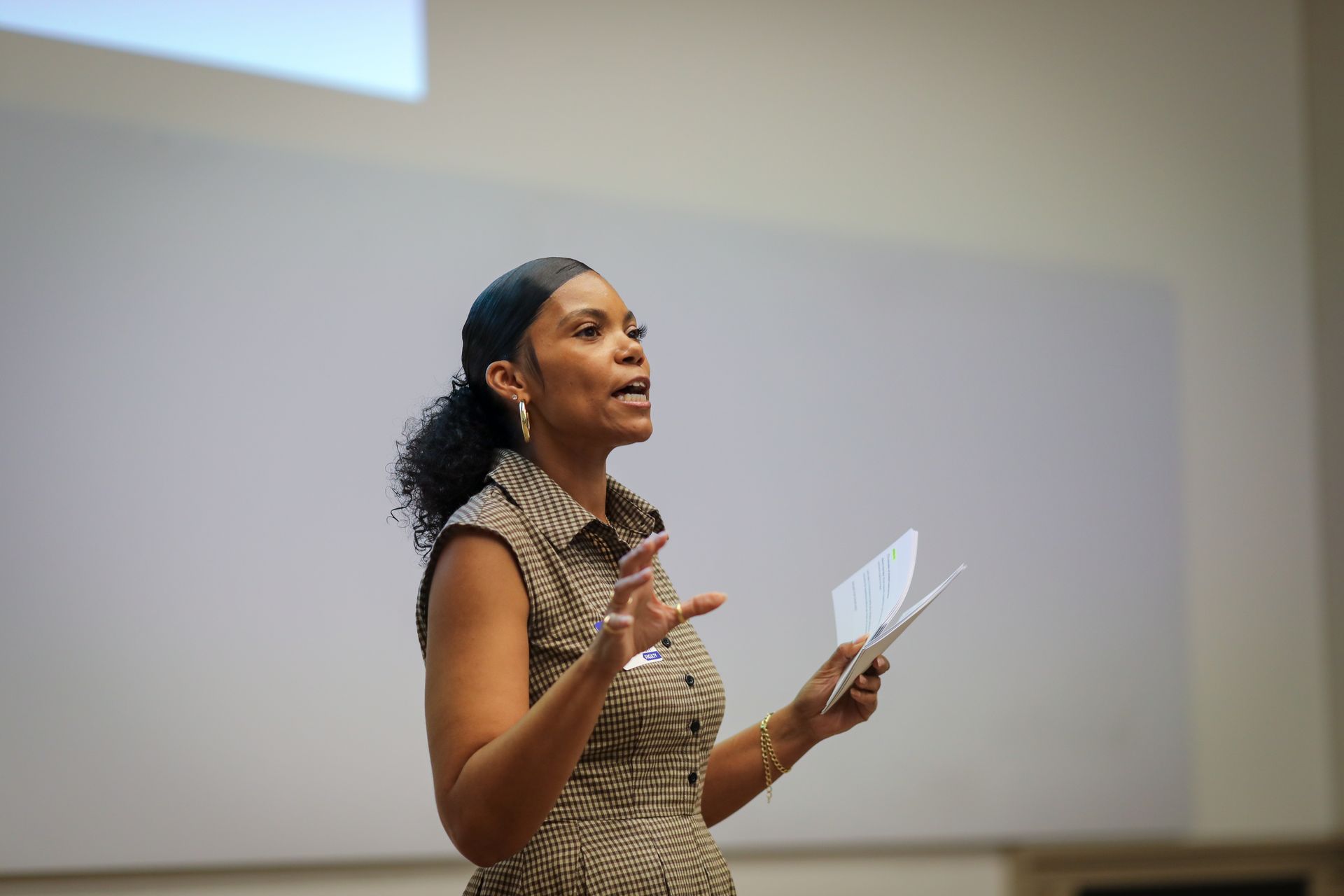 Group of people high-fiving in a modern office, celebrating a success.