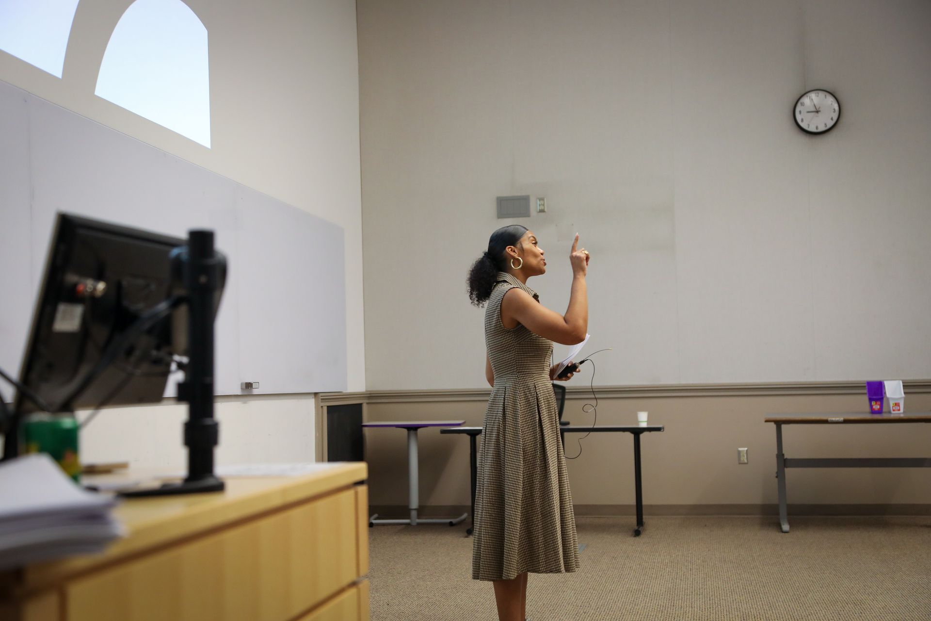 Man speaking in lecture hall with seated audience.