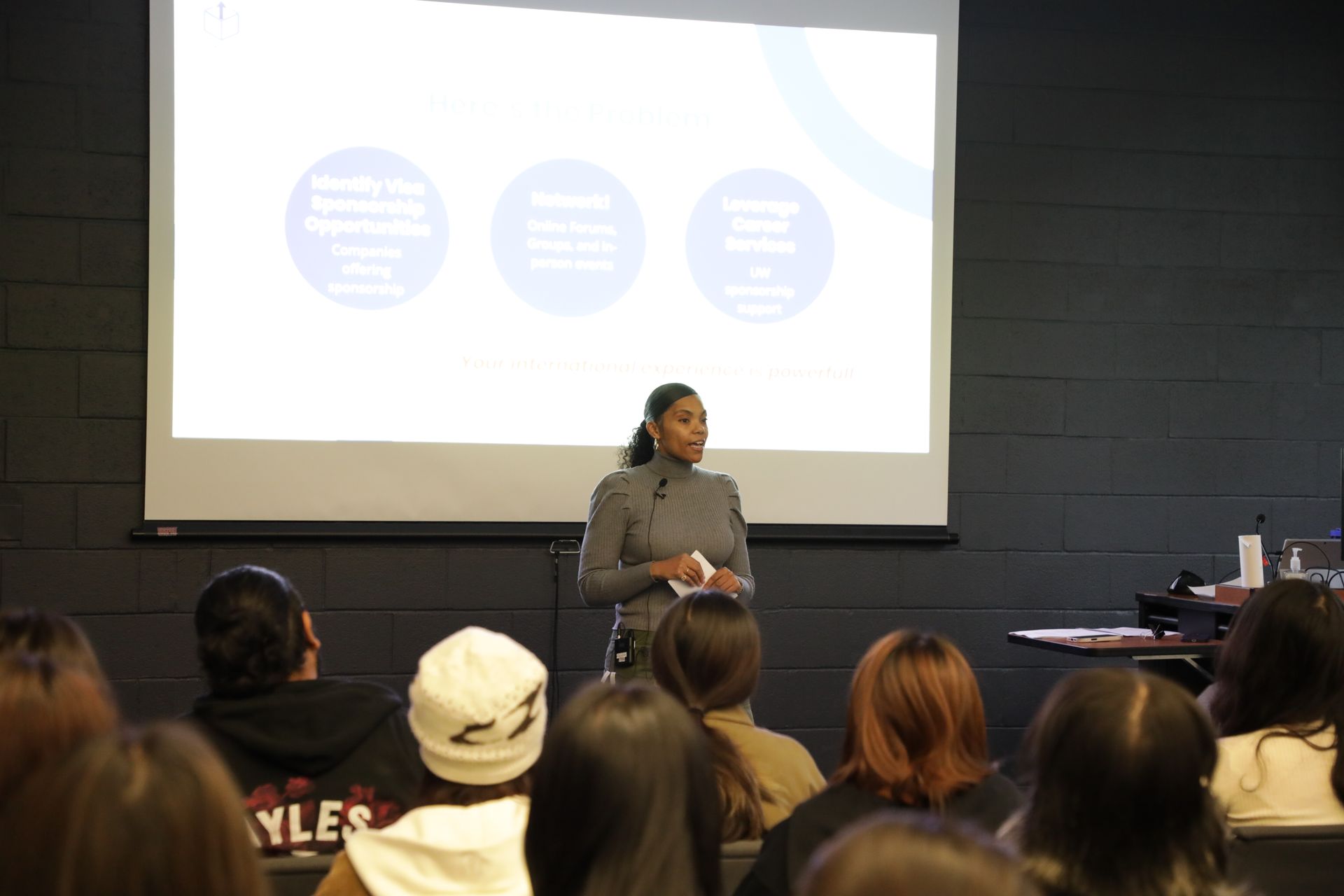 Group of people in meeting around a table with papers, discussing.