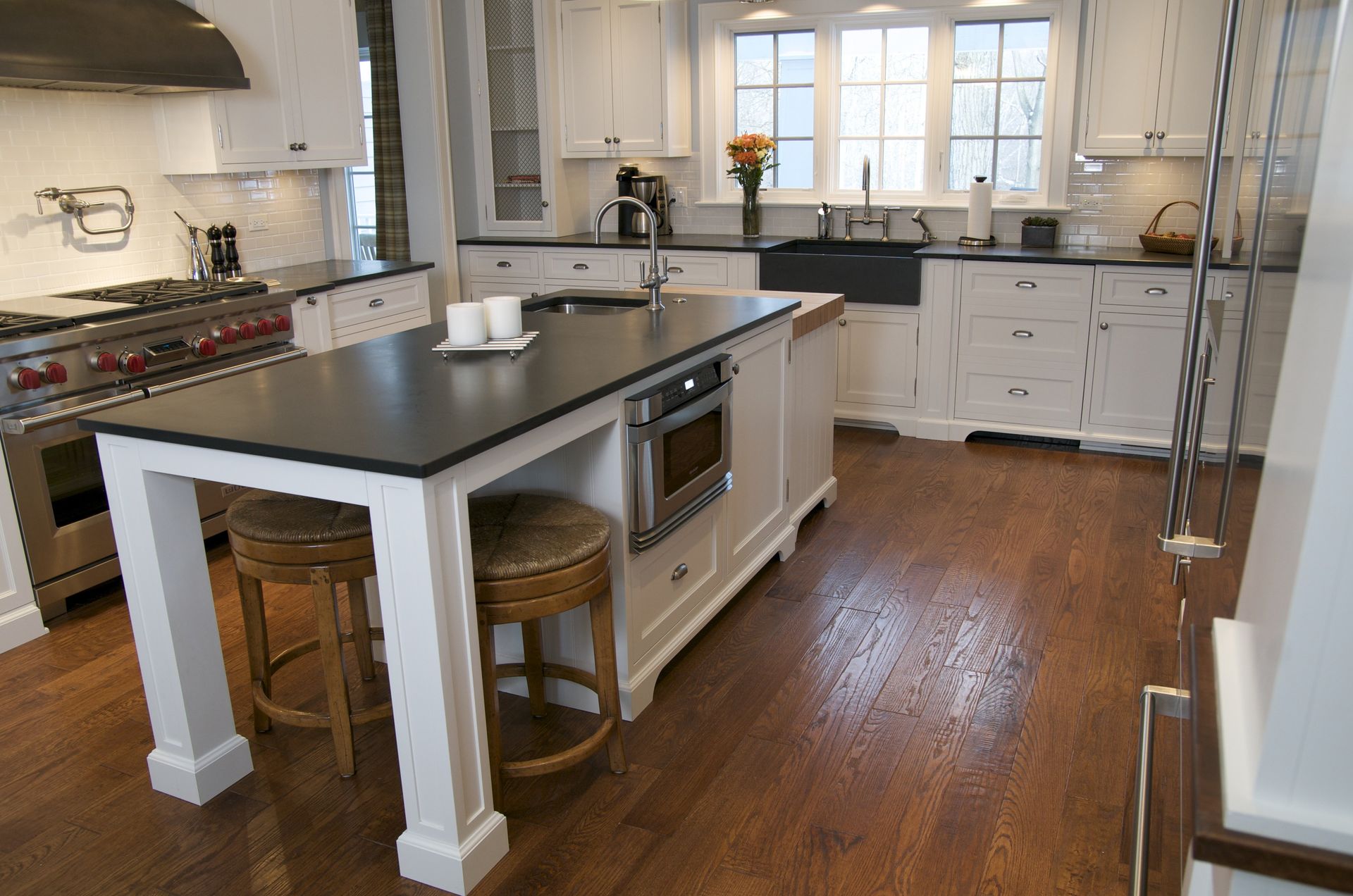 A kitchen with a large island and stools