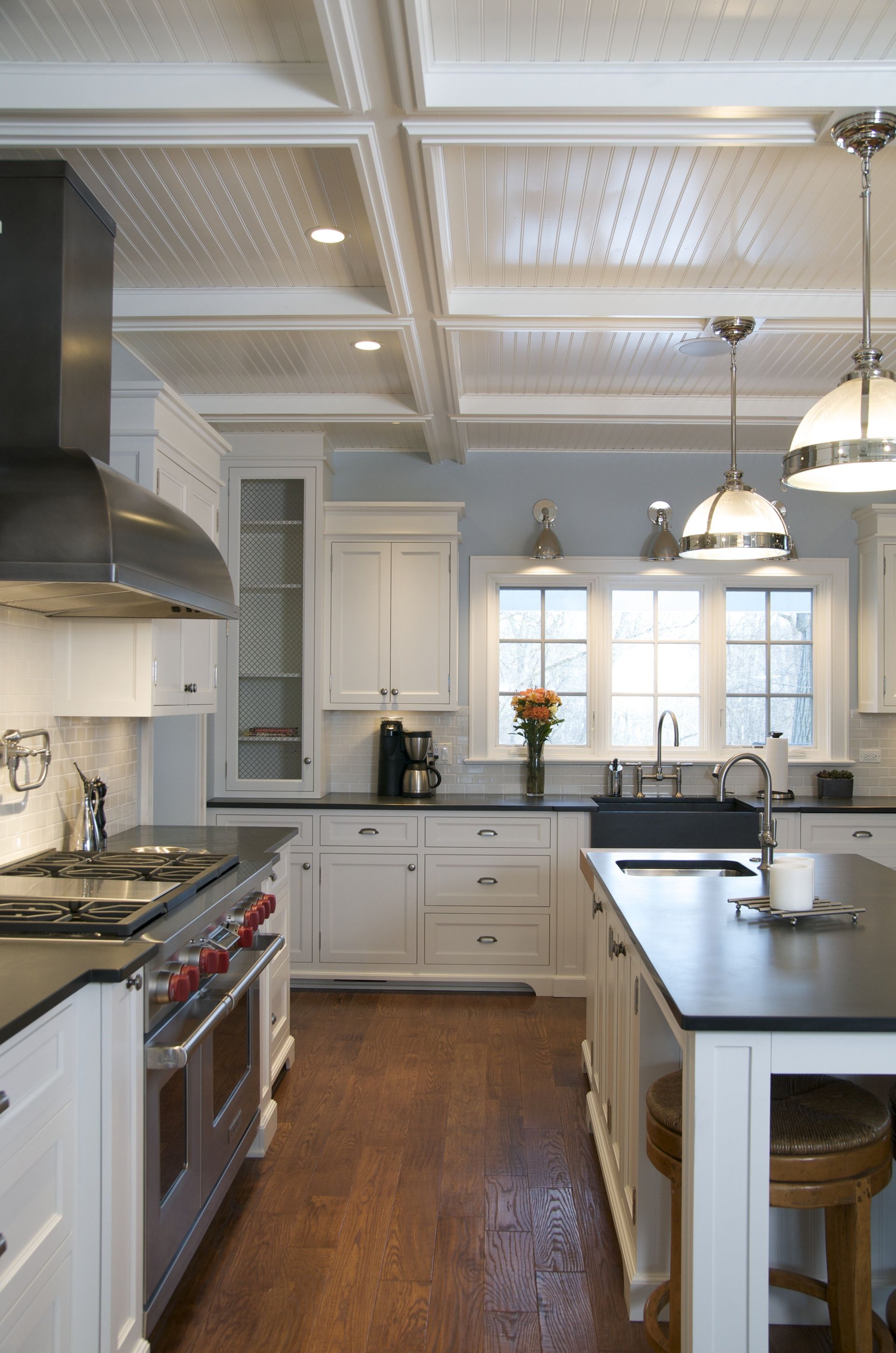 A kitchen with white cabinets and stainless steel appliances