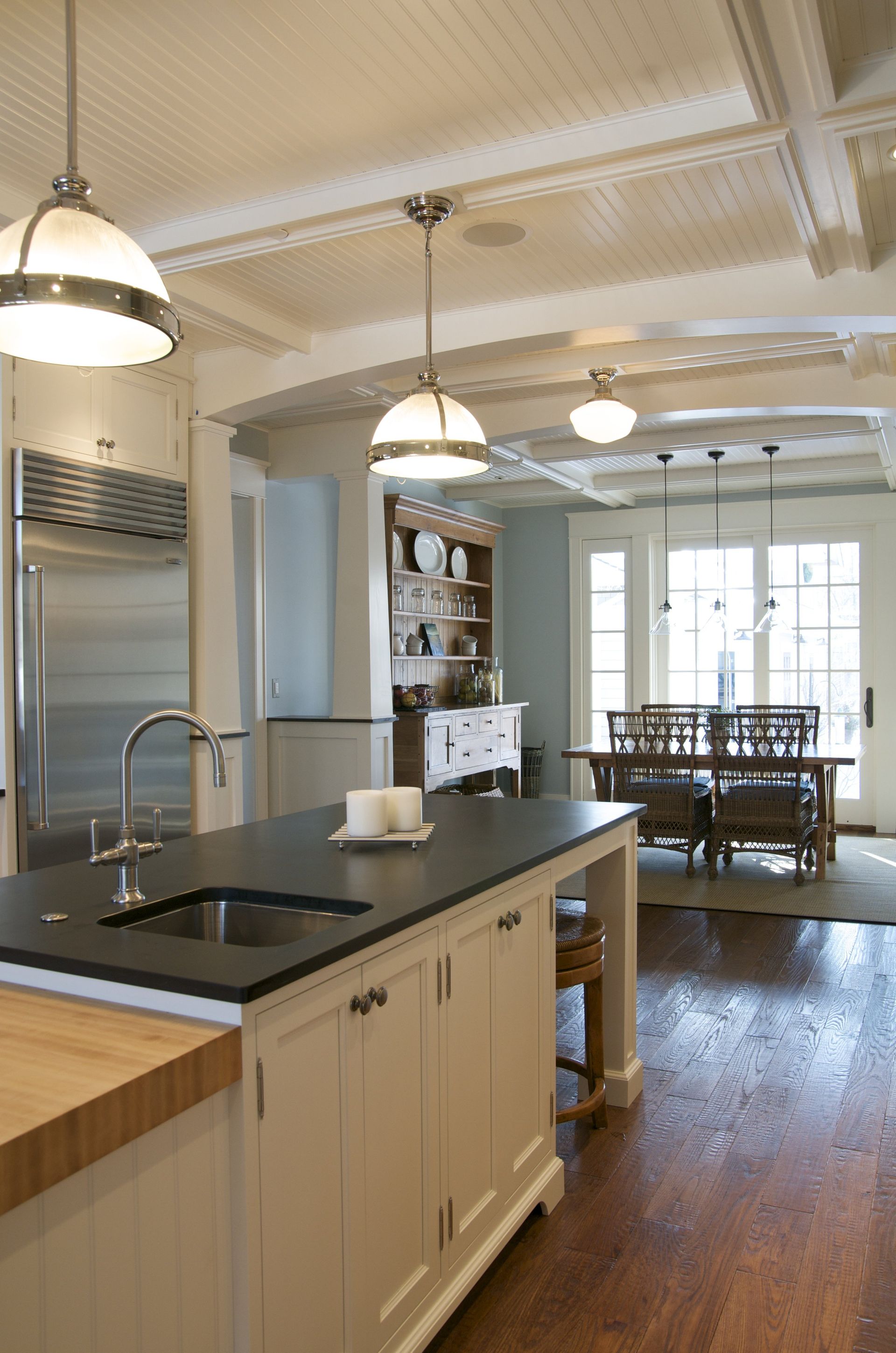 A kitchen with white cabinets and a black counter top