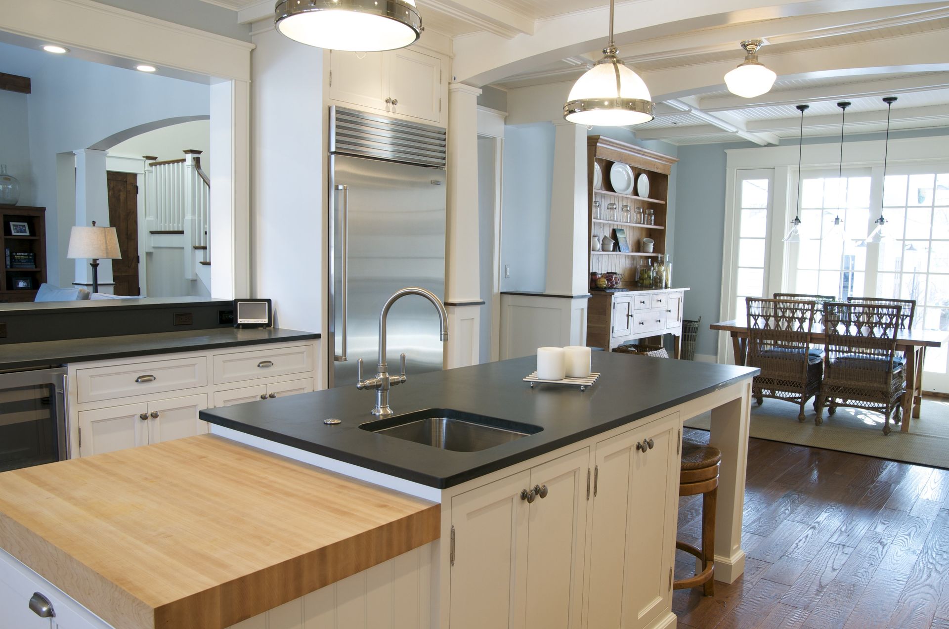 A kitchen with a large island and a sink.