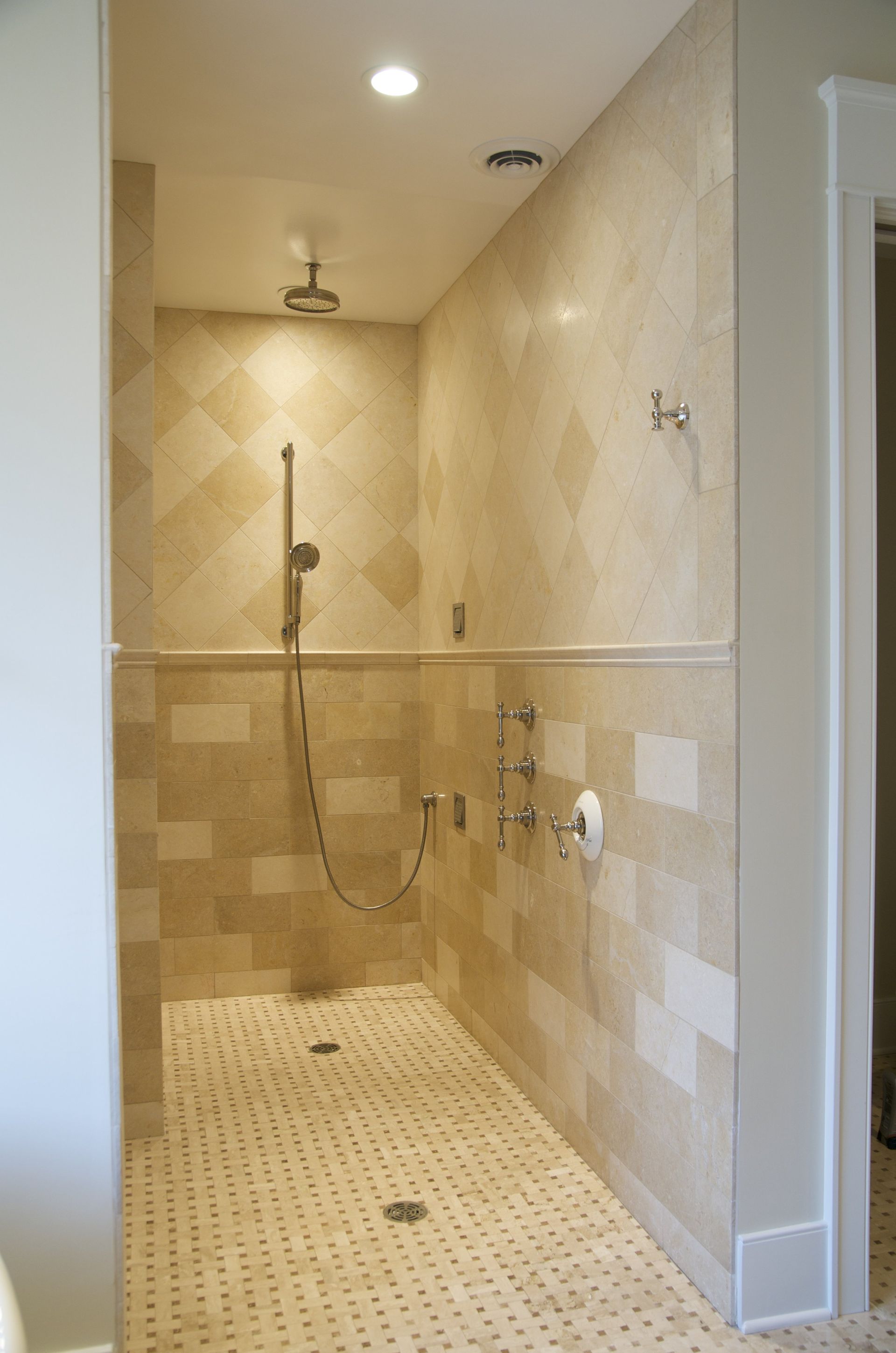 A bathroom with a walk in shower and a tiled floor.