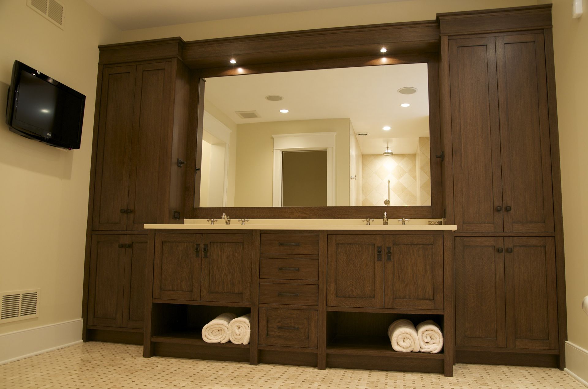 A bathroom with two sinks and a large mirror