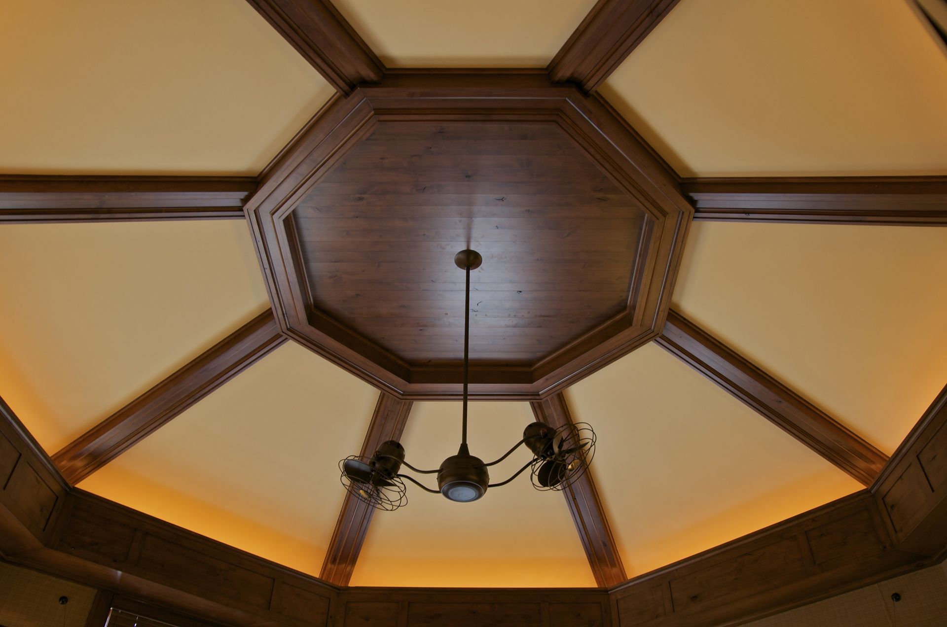 A wooden ceiling with a chandelier hanging from it