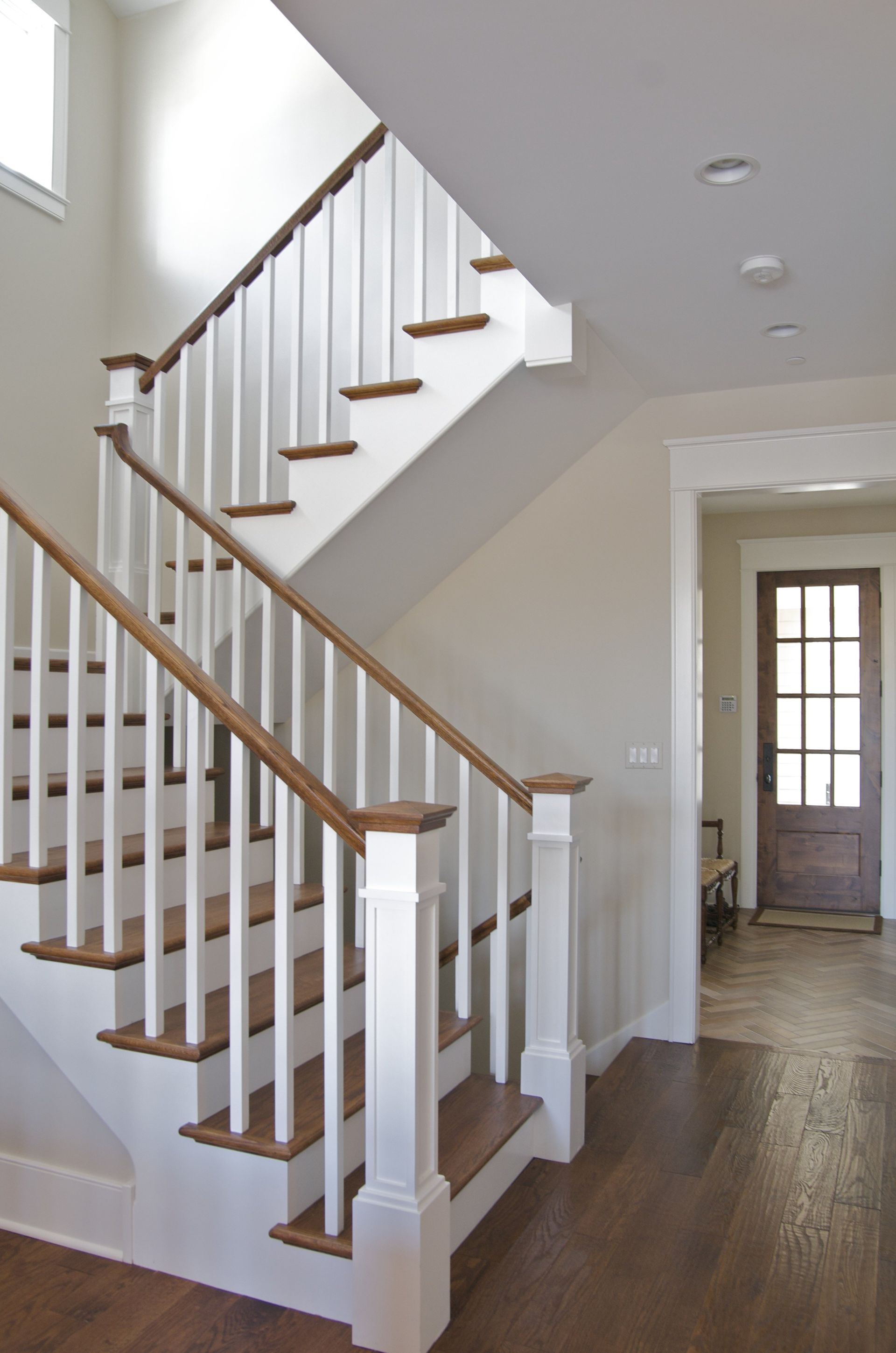 A staircase with white railings and wooden steps